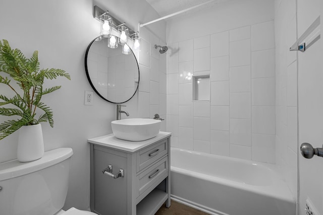 full bathroom with vanity, toilet, and tiled shower / bath combo