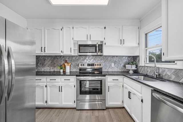 kitchen featuring white cabinetry, sink, and appliances with stainless steel finishes