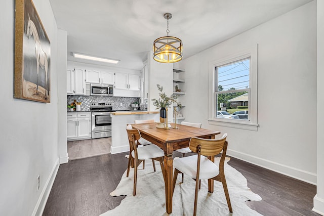 dining space featuring a notable chandelier and dark wood-type flooring