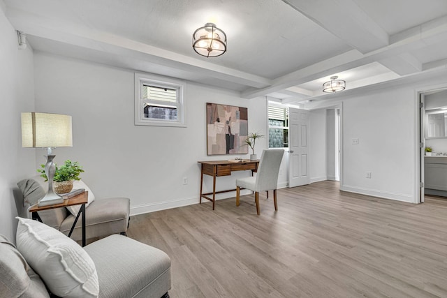 office area with light hardwood / wood-style floors and beam ceiling