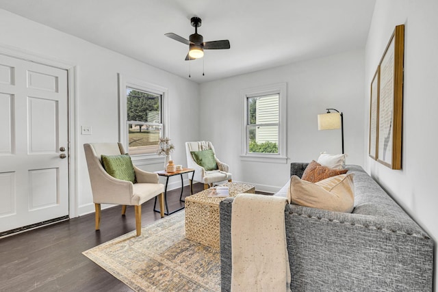 living room with ceiling fan, plenty of natural light, and dark hardwood / wood-style floors