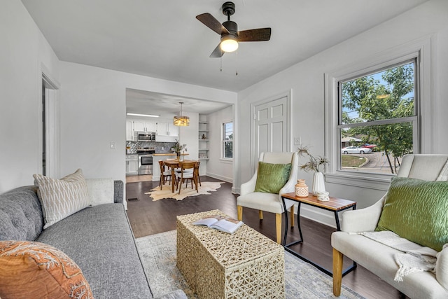 living room with ceiling fan and light wood-type flooring