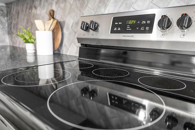 interior details featuring decorative backsplash and stainless steel range with electric cooktop