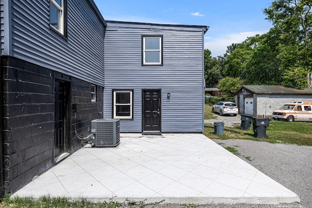 rear view of property with a patio and central AC