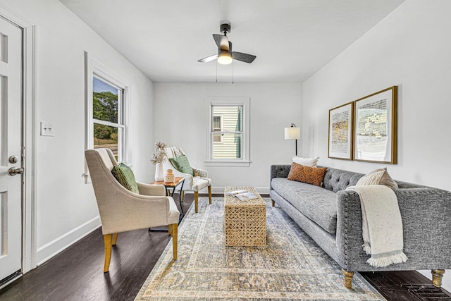 living room with ceiling fan and dark wood-type flooring