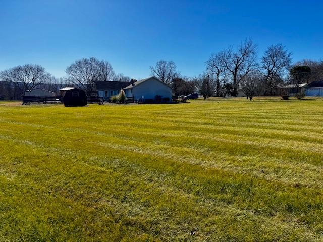 view of yard with a rural view