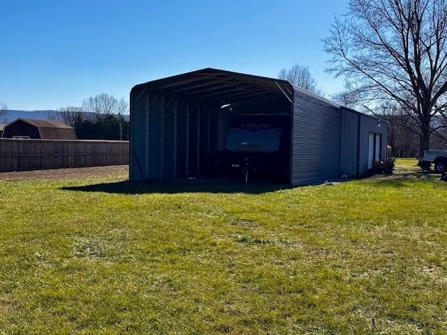 view of outbuilding with a carport and a lawn