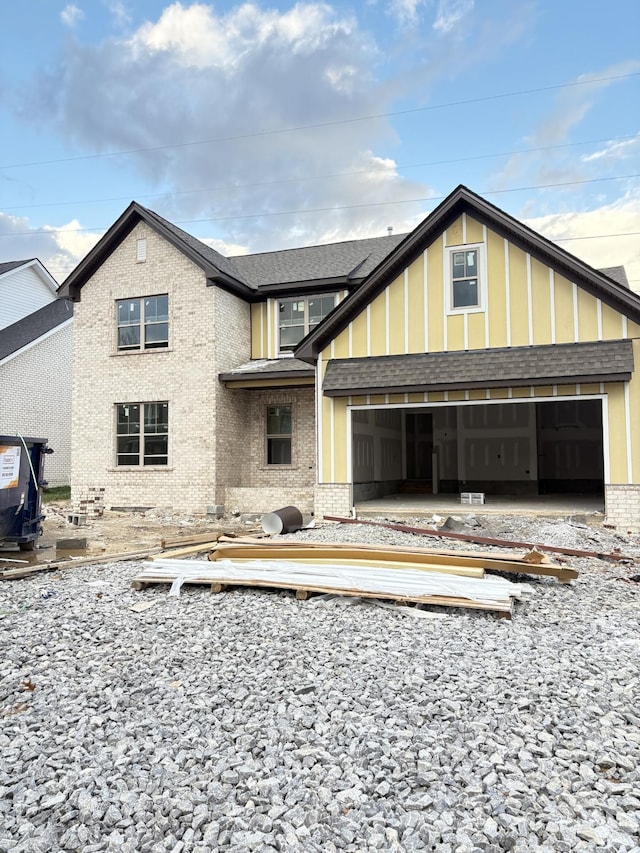 rear view of property featuring a garage