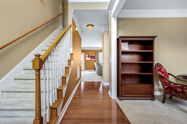 hallway featuring light wood-type flooring and ornamental molding