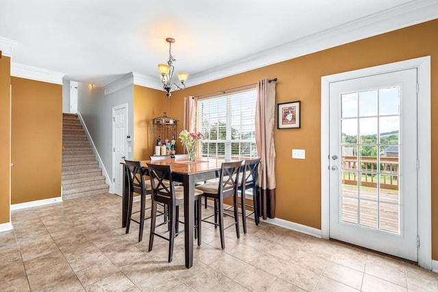 dining space with light tile patterned floors, ornamental molding, and an inviting chandelier