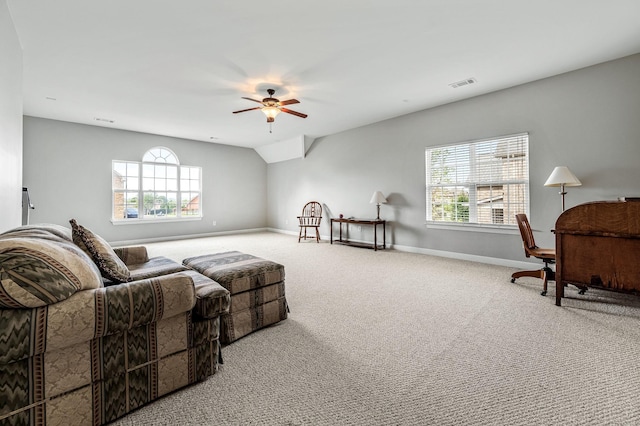 living room with carpet flooring, vaulted ceiling, ceiling fan, and a healthy amount of sunlight