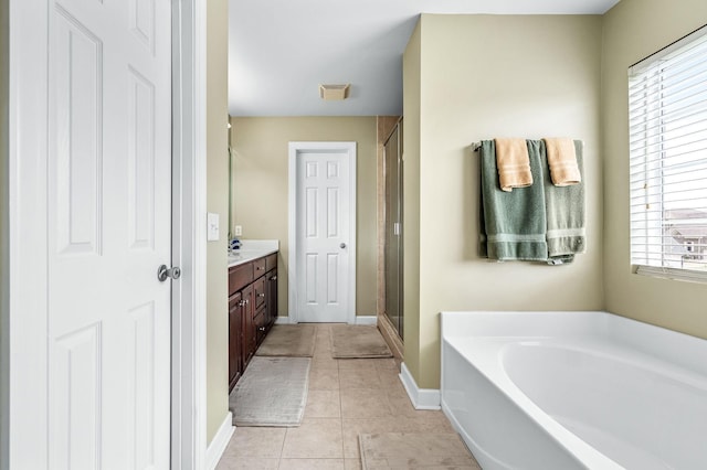 bathroom with tile patterned flooring, vanity, and shower with separate bathtub