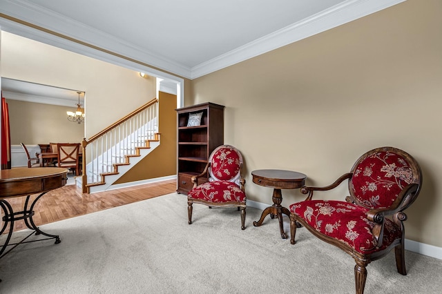 living area with hardwood / wood-style flooring, an inviting chandelier, and crown molding