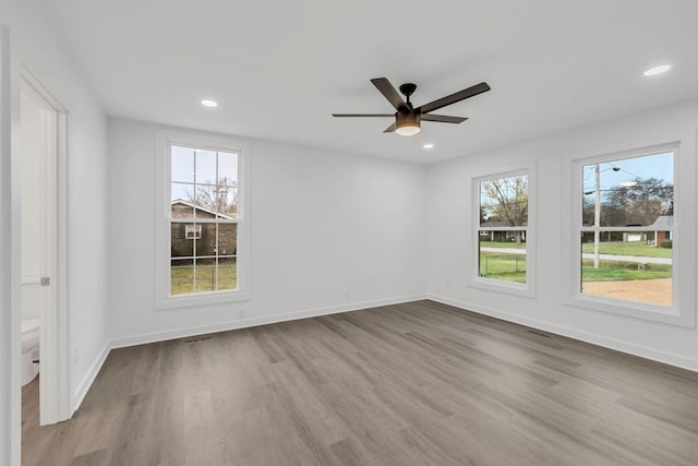 empty room with light wood-type flooring and ceiling fan