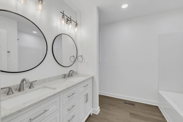 bathroom featuring vanity and hardwood / wood-style flooring