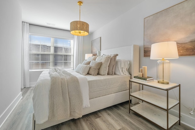 bedroom with hardwood / wood-style flooring