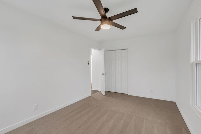 unfurnished room featuring ceiling fan and light colored carpet