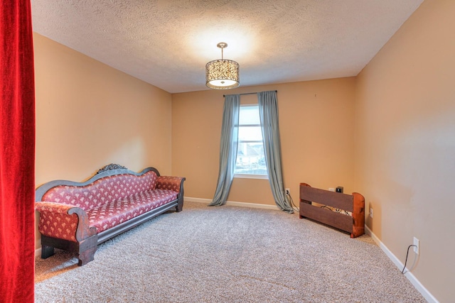 carpeted bedroom featuring a textured ceiling