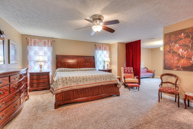 carpeted bedroom with ceiling fan and a textured ceiling