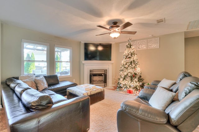 living room with ceiling fan and carpet