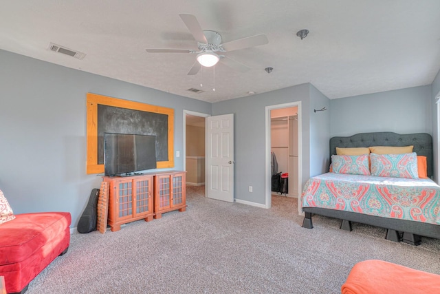 bedroom featuring carpet, a spacious closet, a closet, and ceiling fan