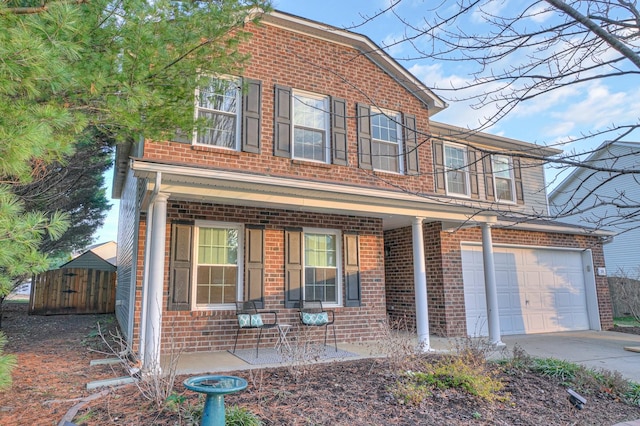 front of property featuring a porch and a garage