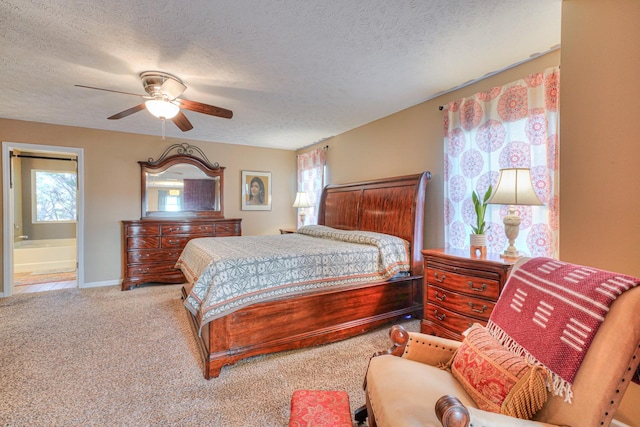 carpeted bedroom with ceiling fan, ensuite bathroom, and a textured ceiling