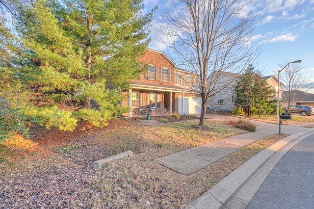 view of front of home featuring a porch and a garage