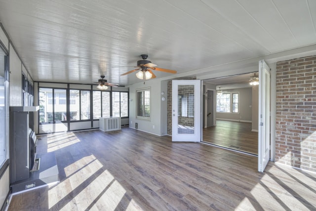 unfurnished sunroom featuring ceiling fan