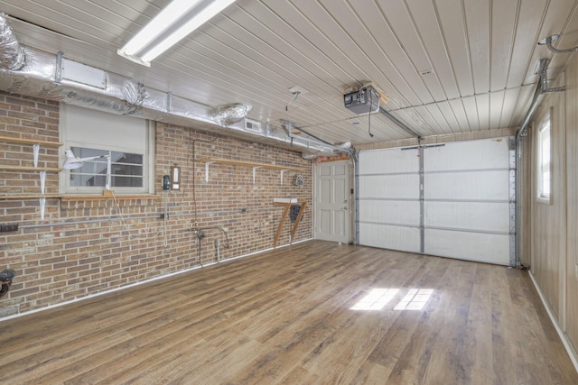 garage with wood ceiling and a garage door opener