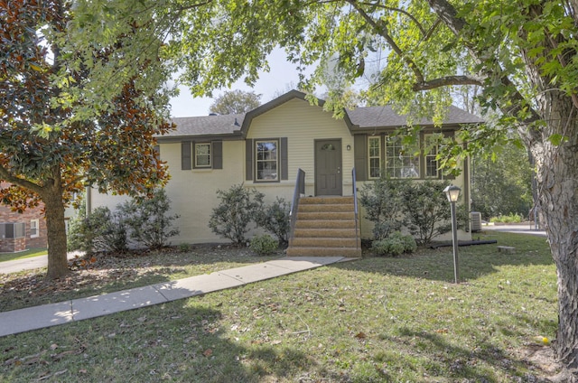 ranch-style house with brick siding, a front lawn, and roof with shingles