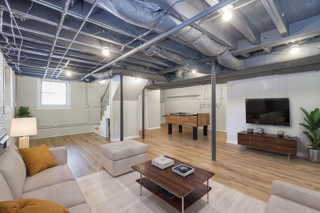 living room with stairway and wood finished floors