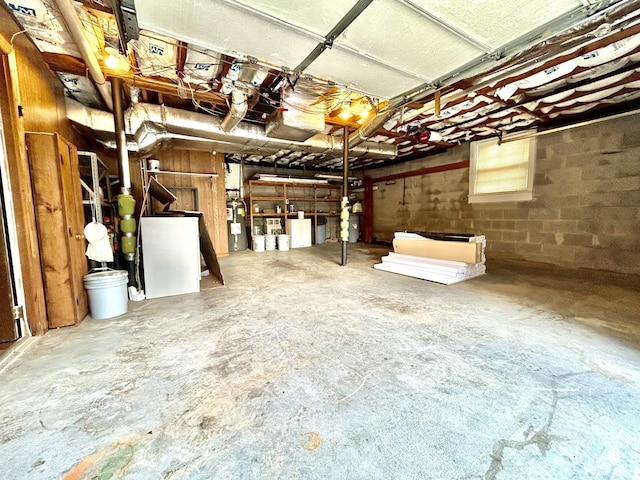 garage with concrete block wall and water heater