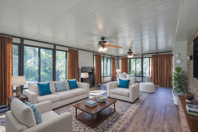 living area with a wall of windows and wood finished floors