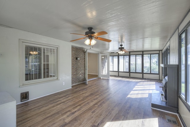 unfurnished sunroom with ceiling fan