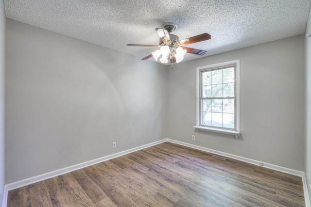 unfurnished room with ceiling fan, hardwood / wood-style floors, and a textured ceiling