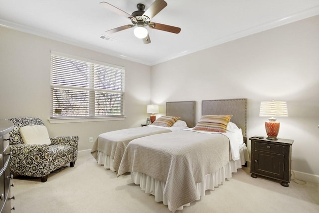 carpeted bedroom with ceiling fan and ornamental molding