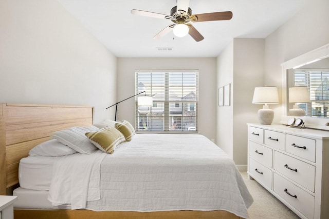 bedroom featuring light colored carpet and ceiling fan