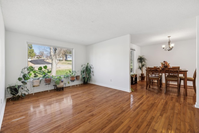 interior space with a chandelier, a textured ceiling, and dark hardwood / wood-style floors