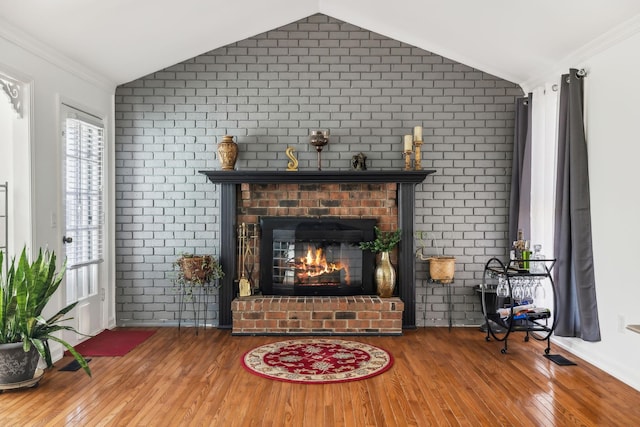 living room featuring brick wall and vaulted ceiling