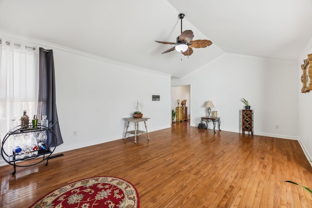 interior space with ceiling fan, hardwood / wood-style floors, lofted ceiling, and ornamental molding