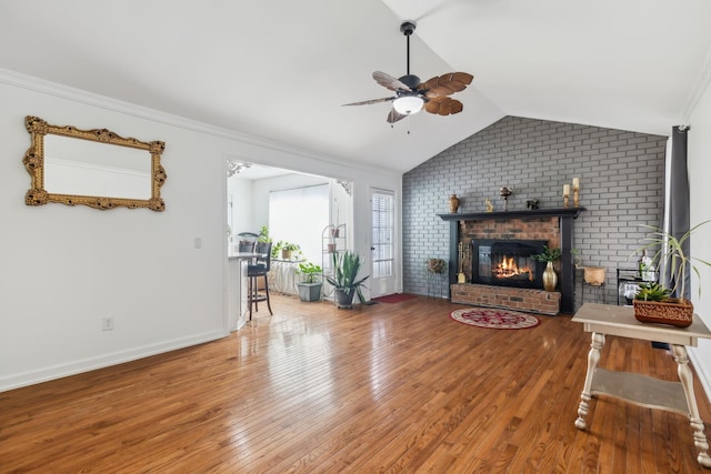 living room featuring a fireplace, hardwood / wood-style floors, ceiling fan, and lofted ceiling