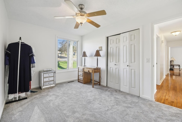 bedroom with ceiling fan, a closet, and light colored carpet