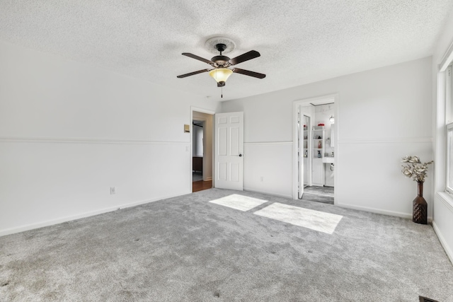 unfurnished room with ceiling fan, carpet floors, and a textured ceiling