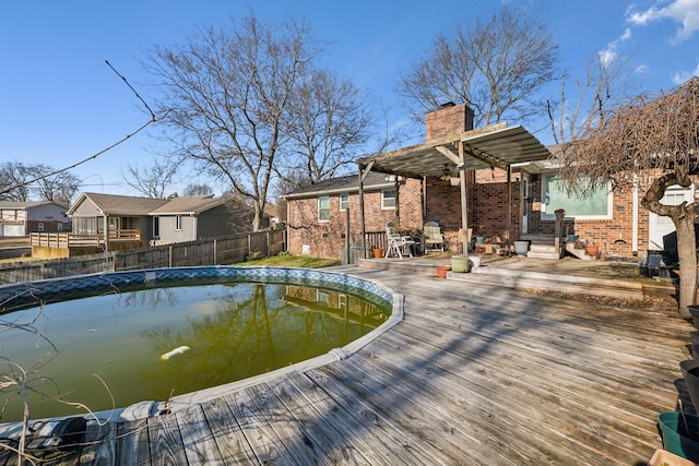 view of swimming pool featuring a pergola and a wooden deck