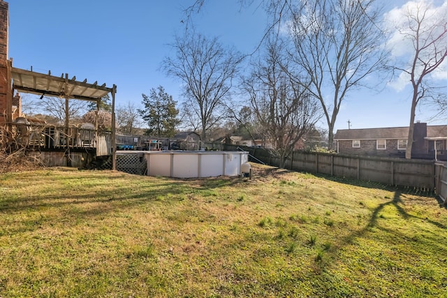 view of yard with a swimming pool side deck