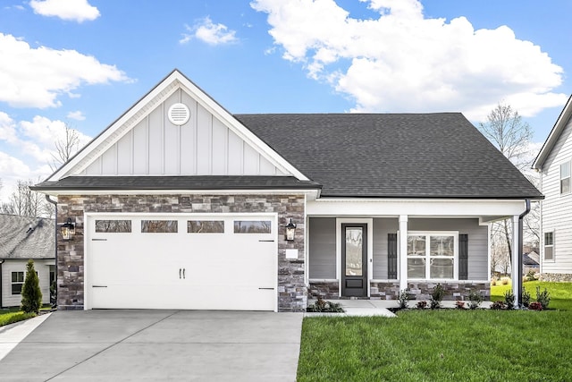 view of front of home with a garage, covered porch, and a front lawn