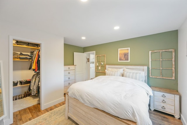 bedroom featuring hardwood / wood-style floors, a walk in closet, and a closet