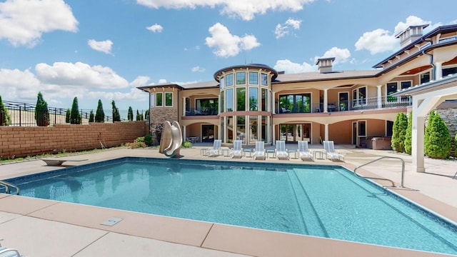 view of pool with a patio and a water slide