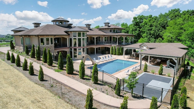 view of pool featuring a gazebo, a patio area, and a water slide